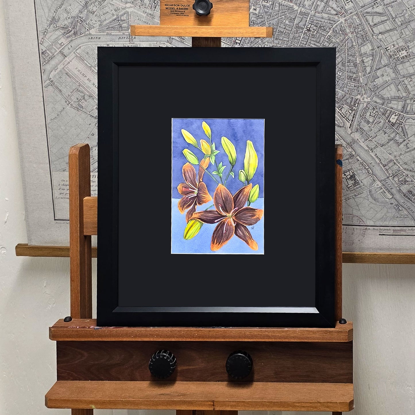 Original Forever Susan Lily watercolor painting displayed in a black frame with a black mat.