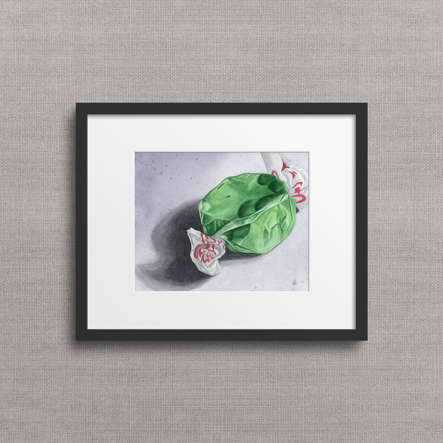 Framed watercolour still life of green apple taffy candy with twisted wrapper — minimalist archival giclée print. By Heidi Leduc