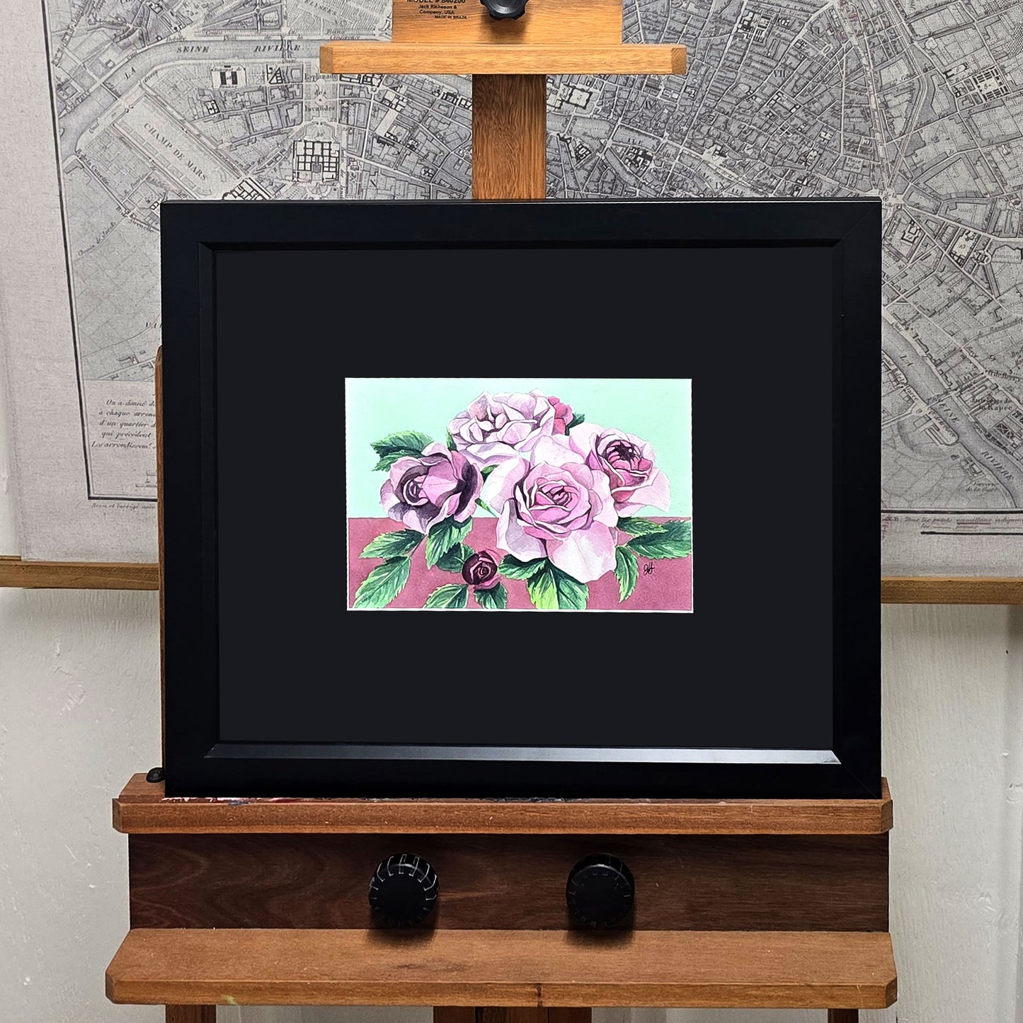 Original framed watercolor painting of a Lavender Veranda Rose with soft lavender blooms against a teal green and purple background.